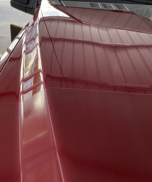 car-paint-scratch-body-dent-repair-near-me-sumter-sc Smooth red vehicle hood after dent repair.