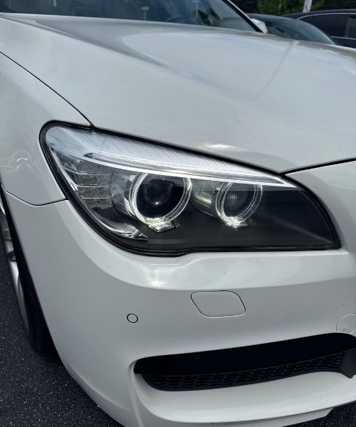 Clean restored BMW headlight with clear lens and bright finish